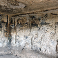 Soğmatar cave-temple with large figures and inscriptions carved in the walls.